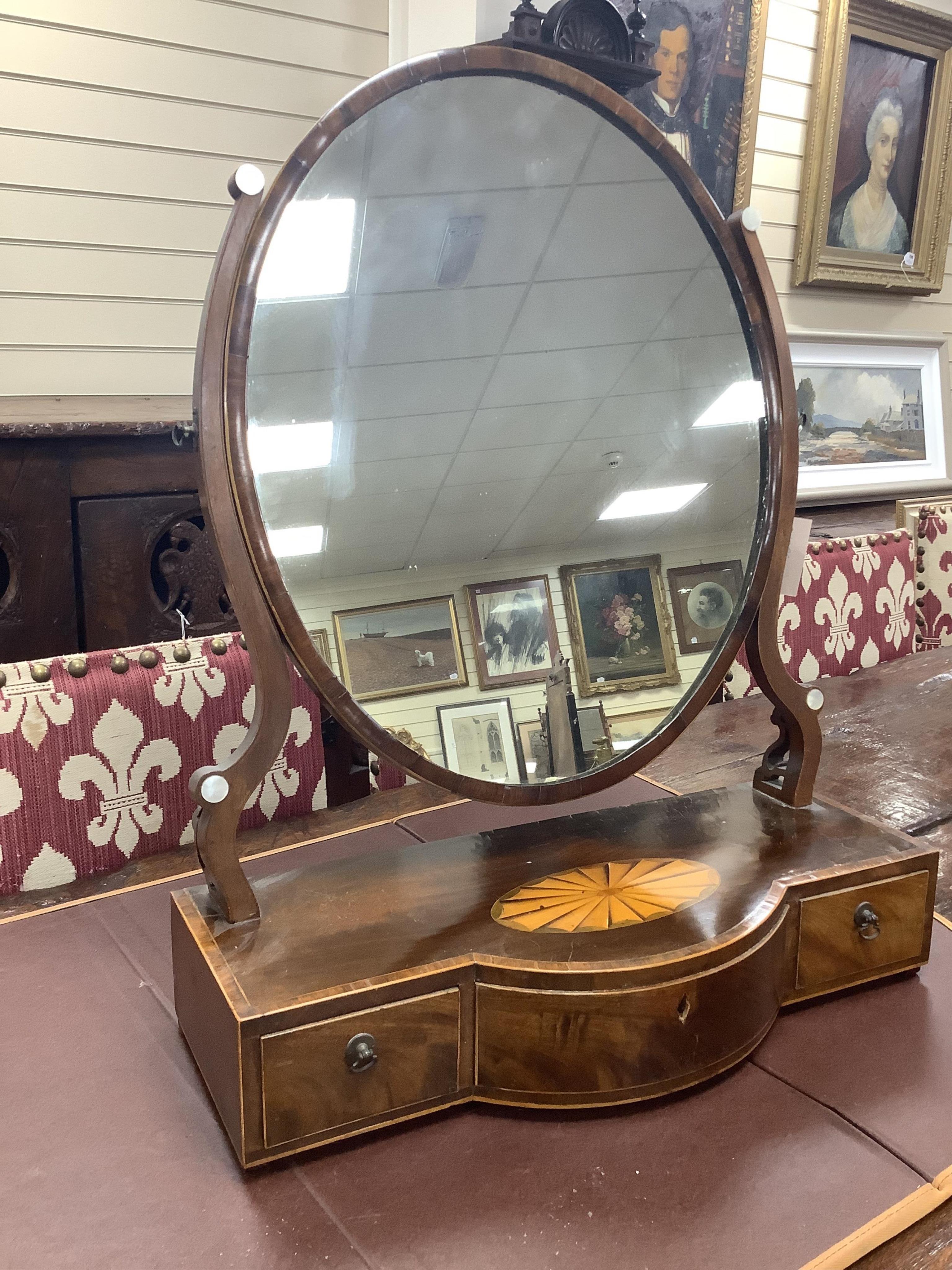 A George III mahogany satinwood paterae inlaid bowfront toilet mirror, width 57cm depth 24cm height 73cm